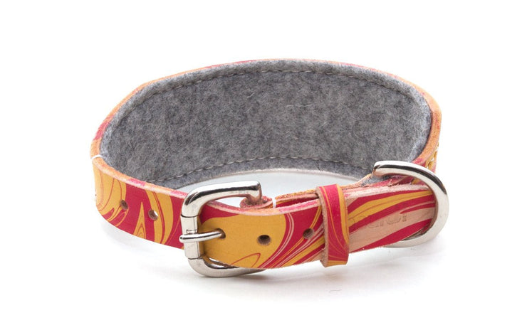 Leather hound collar, patterned red and yellow, showing buckle and grey felt lining