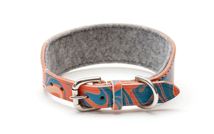 Leather hound collar, patterned red and blue, showing buckle and felt lining