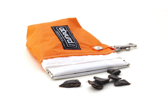 orange dog treat bag showing squeeze clip opening and dog treats